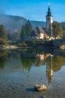 Slovenia, Bled, Lake Bled. Church reflects in lake. Art Print